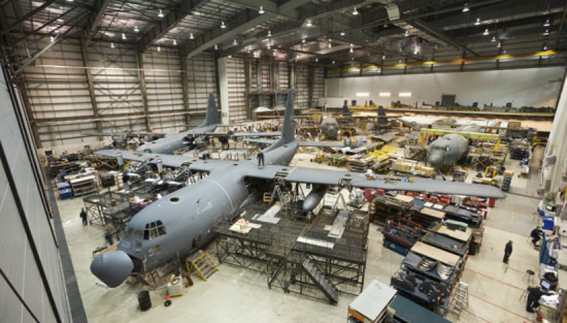 Military aircraft maintenance inside a large steel-framed defence hangar